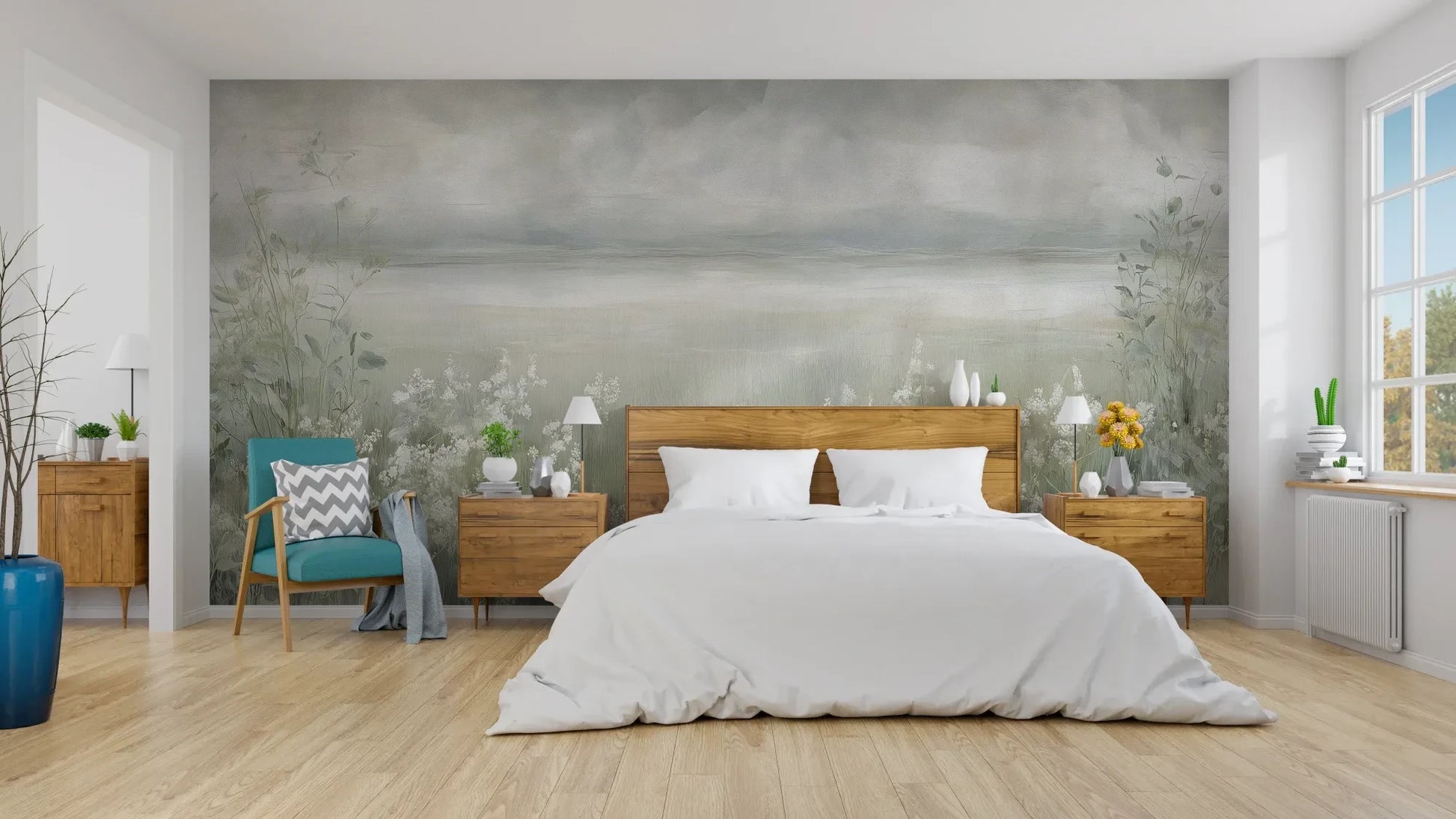 Wzór fototapety MISTY BLOOM FIELDS - tapeta z mglistą łąką i dzikimi kwiatami pokazanej w aranżacji sypialni.