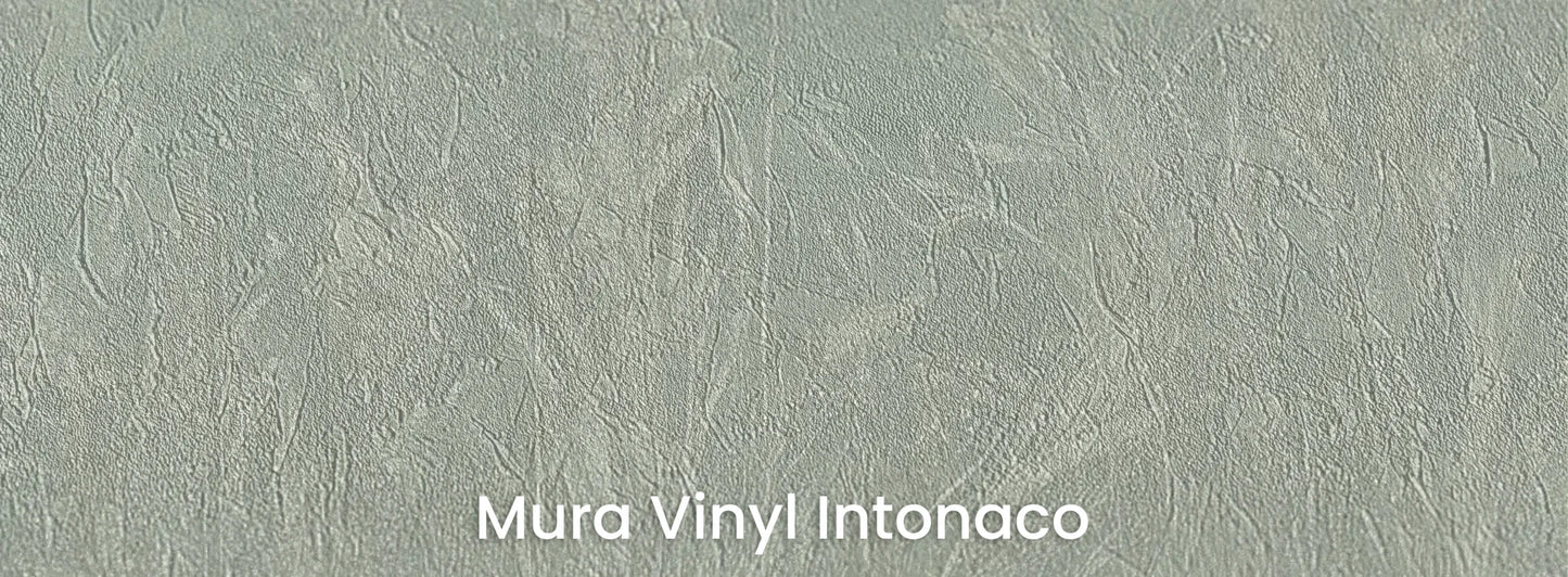 Zbliżenie na fototapetę MEADOW REVERIE - tapeta z delikatnym wzorem traw na seledynowym tle na podłożu o strukturze tartego tynku.