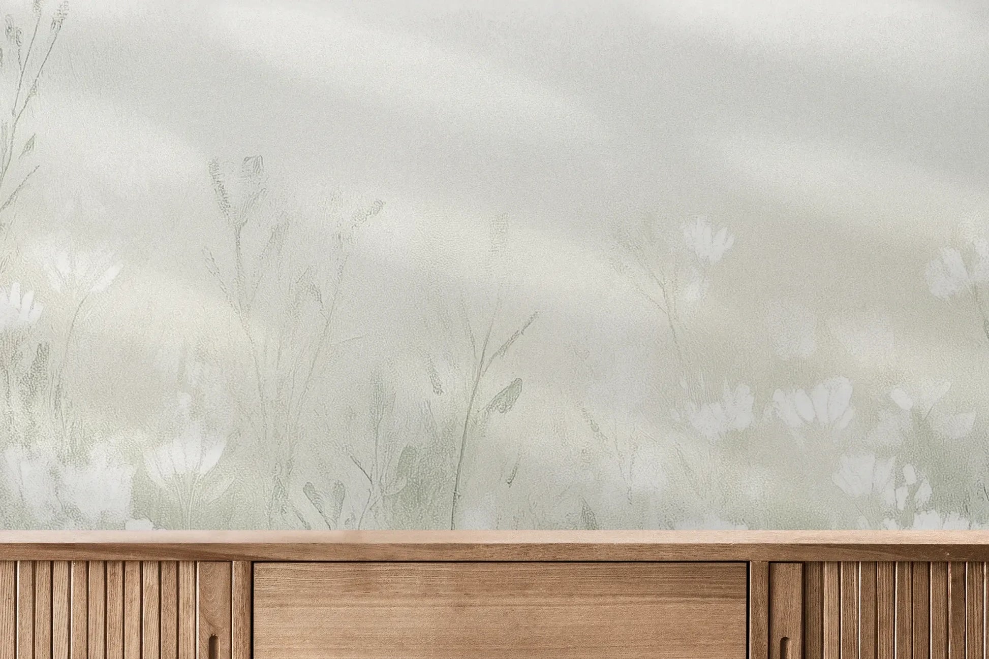 Fototapeta CLOUDED BLOSSOMS - tapeta z mglistą łąką pokazana w aranżacji wnętrza z akcentem na ścianie.