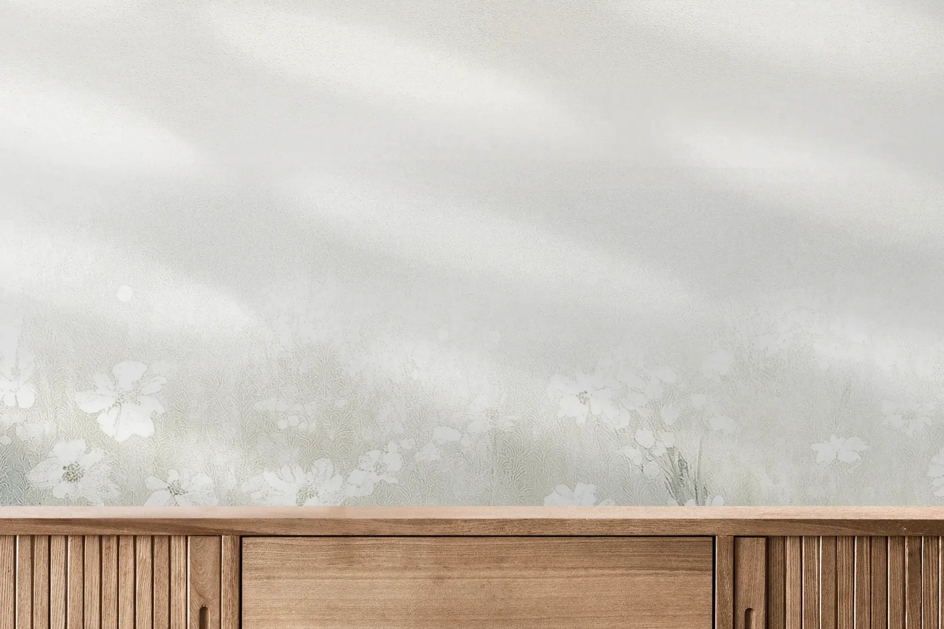 Fototapeta PEARL MEADOW - tapeta z mglistą łąką w stonowanych beżach pokazana w aranżacji wnętrza z akcentem na ścianie.