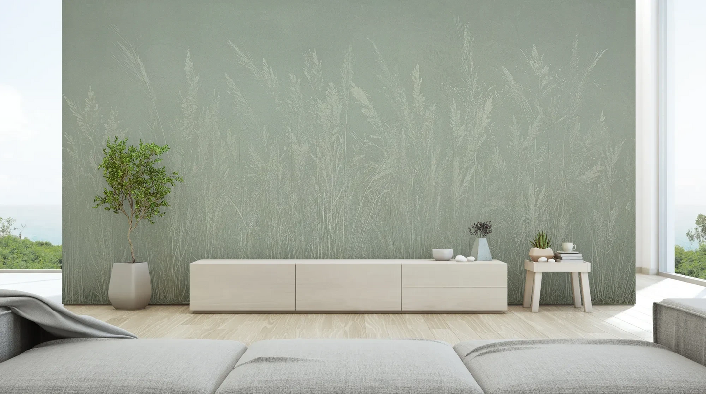 Wzór fototapety MEADOW REVERIE - tapeta z delikatnym wzorem traw na seledynowym tle pokazanej w aranżacji salonu.