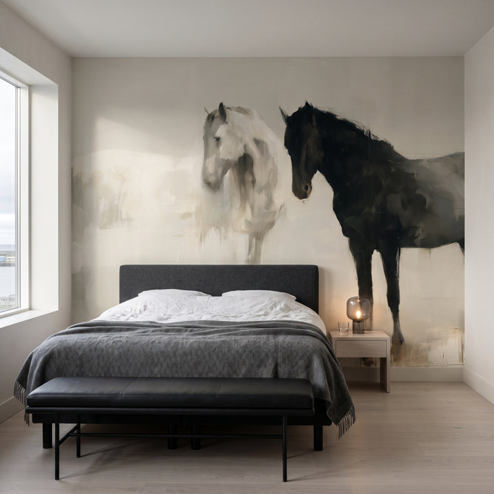 CHALK AND COAL en una ambientación de suite de hotel: dos caballos sobre una cama con cabecero grafito y un banco de cuero negro
