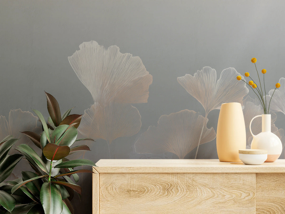 LILAC STUCCO close up – cream leaf fans on a grey ground above a pale wooden chest of drawers with vases