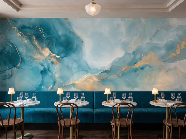 PEACOCK AGATE w aranżacji restauracji: cała ściana nad długą aksamitną kanapą i okrągłymi stolikami z marmurowymi blatami