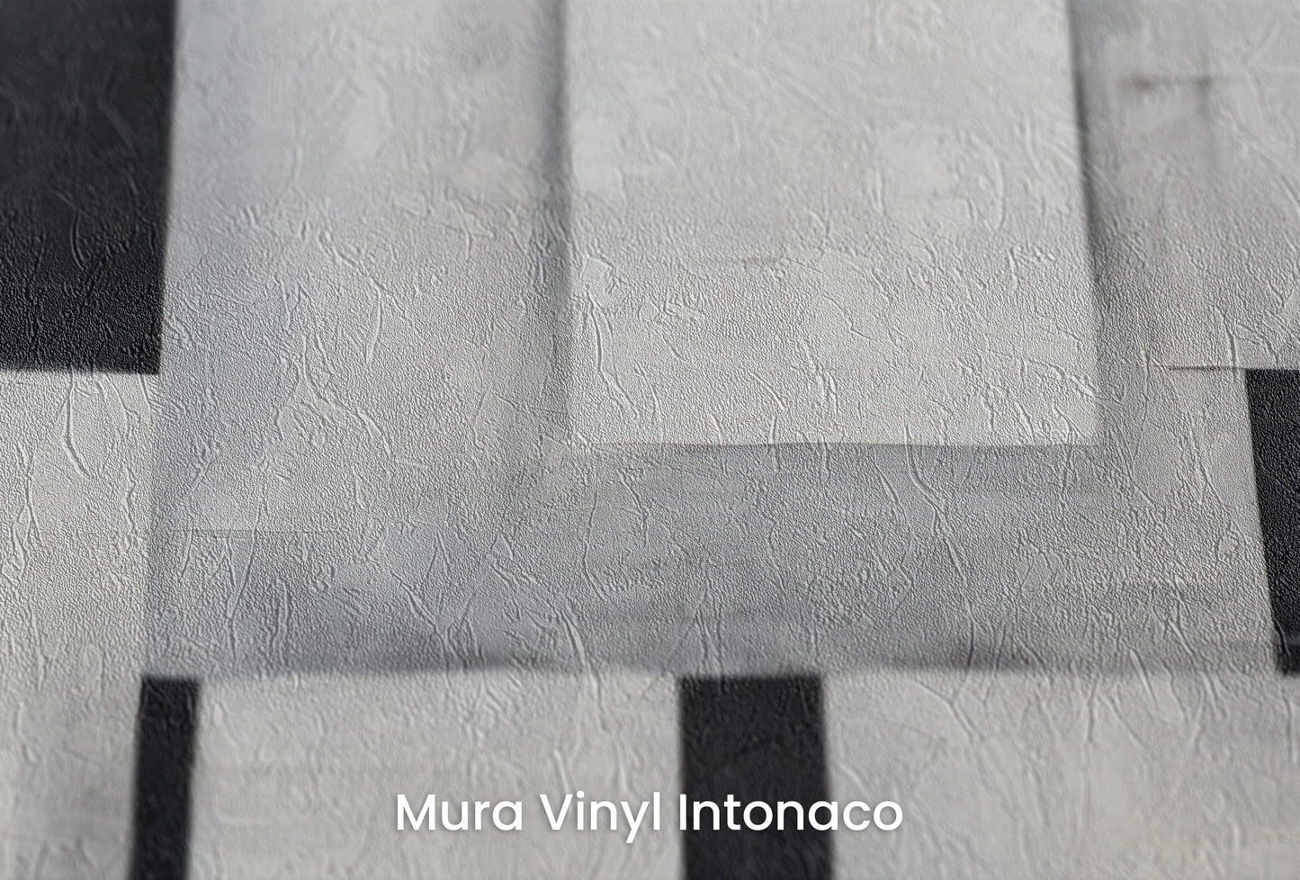 Zbliżenie na artystyczną fototapetę o nazwie Monochrome Blocks na podłożu Mura Vinyl Intonaco - struktura tartego tynku.
