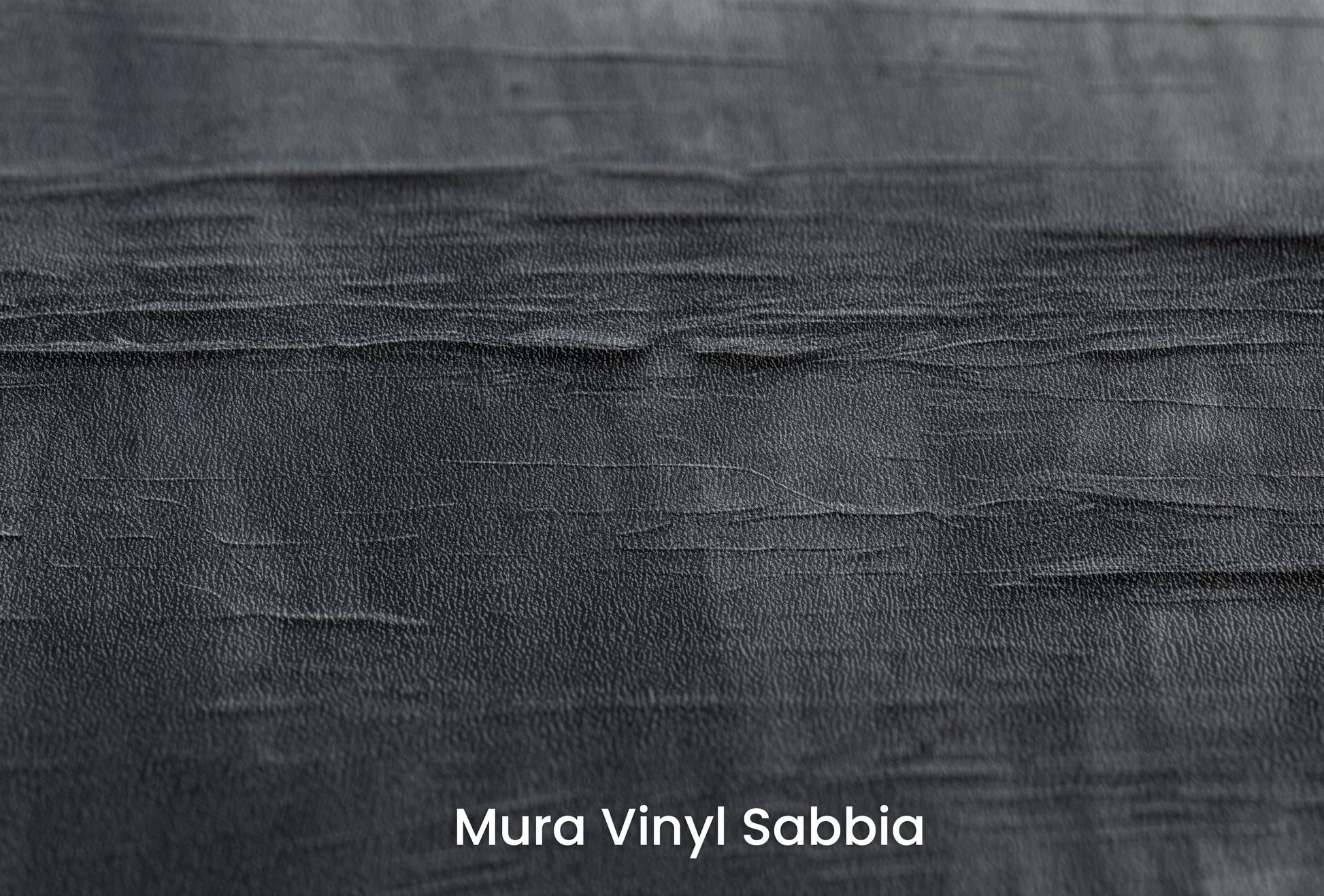 Zbliżenie na artystyczną fototapetę o nazwie Canvas Grayscale na podłożu Mura Vinyl Sabbia struktura grubego ziarna piasku.