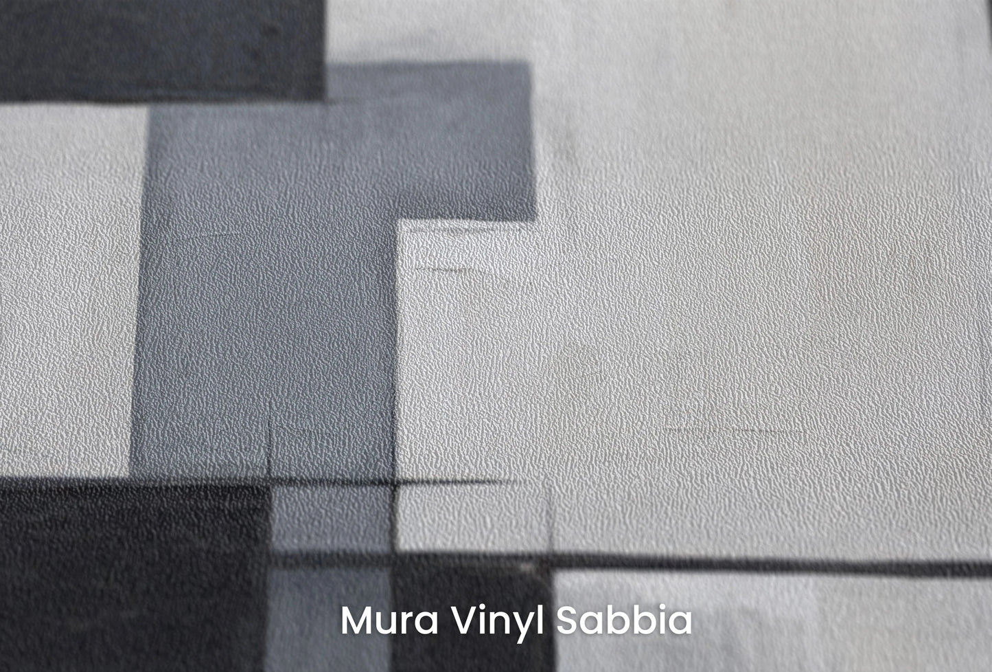 Zbliżenie na artystyczną fototapetę o nazwie Monochromatic Mosaic na podłożu Mura Vinyl Sabbia struktura grubego ziarna piasku.