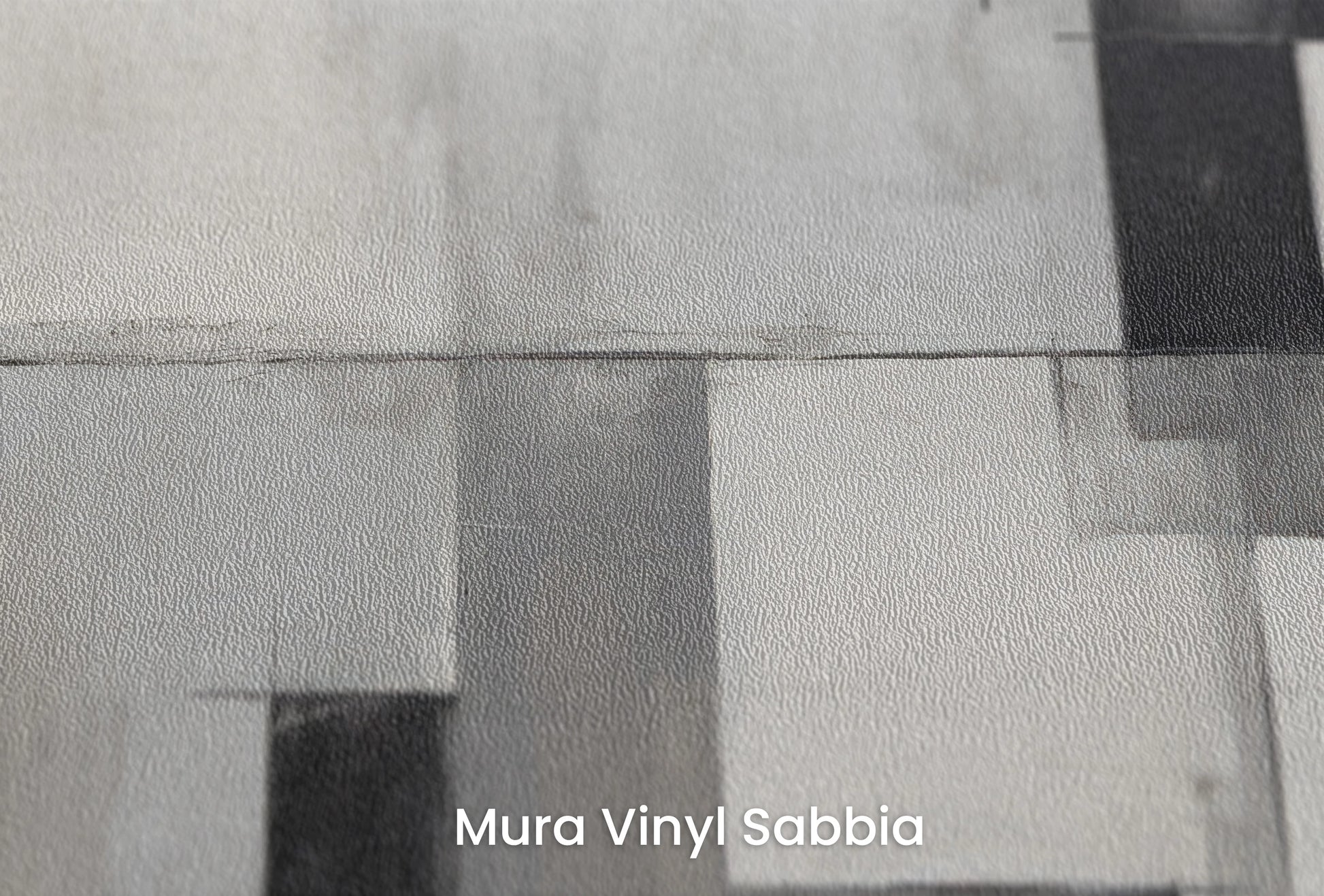 Zbliżenie na artystyczną fototapetę o nazwie Geometric Intrigue na podłożu Mura Vinyl Sabbia struktura grubego ziarna piasku.